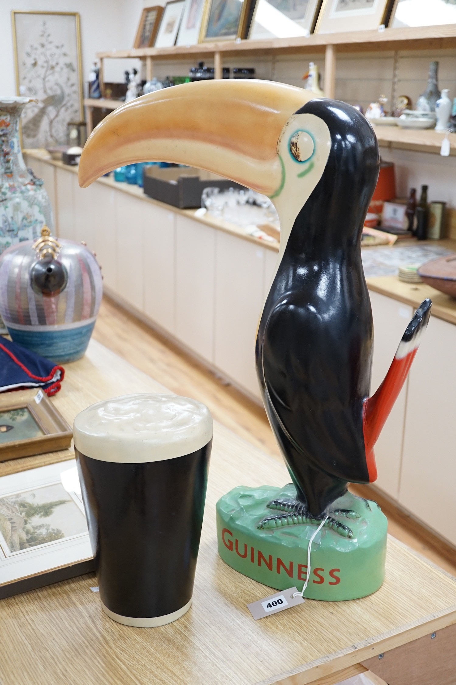 A large composition Guinness toucan, 66cm, and related pint ornament